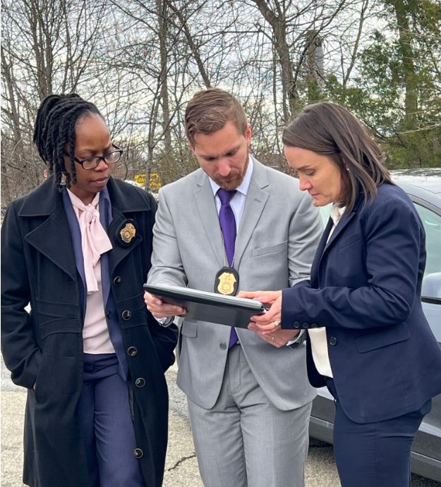 Army CID Agents review evidence on a tablet at an incident scene